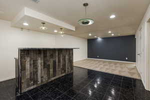 Empty room featuring dark tile flooring and a textured ceiling