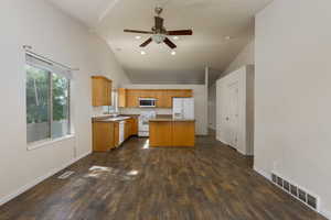 Kitchen with a kitchen island, high vaulted ceiling, dark hardwood / wood-style flooring, and white appliances