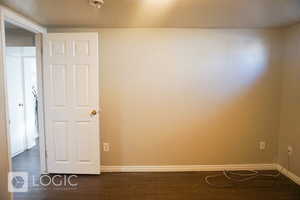 Unfurnished room featuring dark hardwood / wood-style flooring