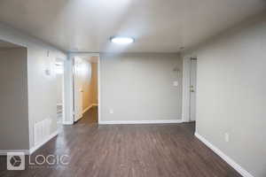 Unfurnished room featuring dark hardwood / wood-style floors