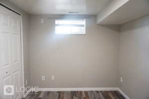 Basement with hardwood / wood-style flooring