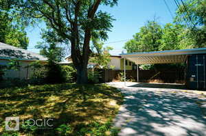 View of yard with a carport and a storage shed