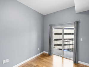 Empty room featuring a wealth of natural light and light hardwood / wood-style flooring