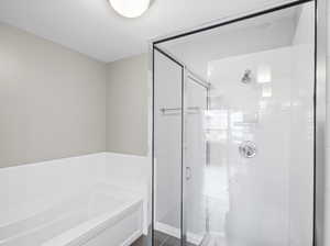 Bathroom featuring tile flooring and separate shower and tub