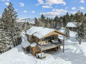 Snow covered property featuring a mountain view