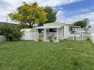 Exterior space featuring an outdoor structure and a front lawn