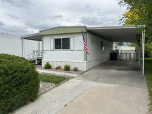 View of front of house featuring a carport