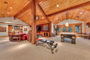 Recreation room featuring wood ceiling, beamed ceiling, light carpet, pool table, and french doors