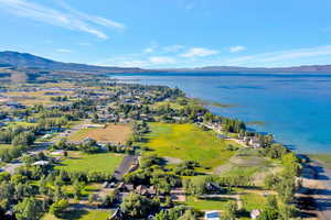 Drone / aerial view featuring a water and mountain view