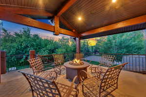 Patio terrace at dusk featuring a fire pit