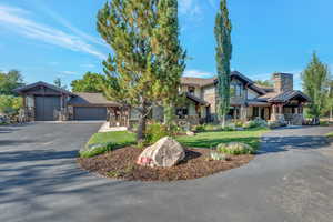 Craftsman-style house featuring a garage and a front lawn