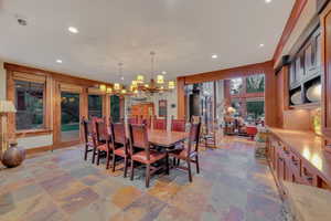 Tiled dining area featuring a chandelier