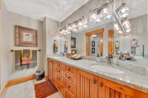 Bathroom featuring tile flooring and dual vanity