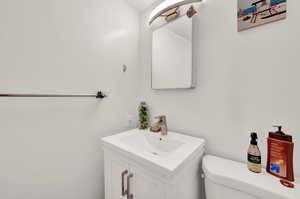 Bathroom with large vanity and toilet