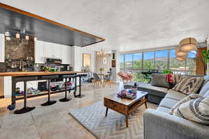 Tiled living room featuring a chandelier