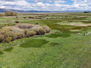 Birds eye view of property with a rural view and a mountain view