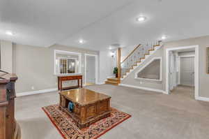 Carpeted living room with a textured ceiling