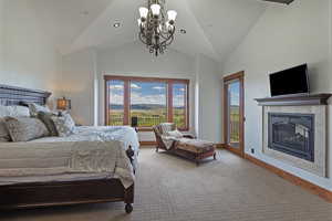 Primary Bedroom on the Main Level with a Fireplace and Deck Access to Enjoy the Beautiful Views