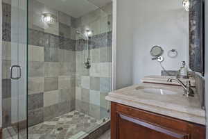 Bathroom featuring walk in shower and vanity