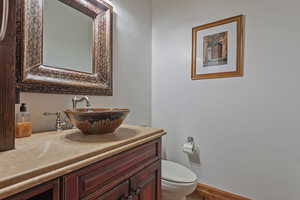 Bathroom featuring oversized vanity and toilet