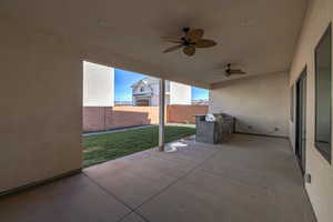 View of terrace featuring a grill and ceiling fan