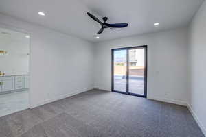 Unfurnished room featuring ceiling fan and light carpet