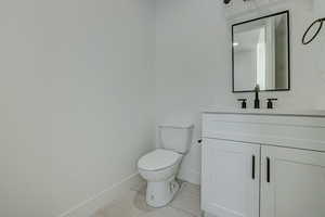 Bathroom with tile floors, toilet, and vanity with extensive cabinet space