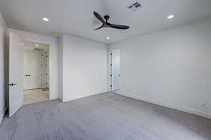 Unfurnished bedroom featuring ceiling fan and light carpet