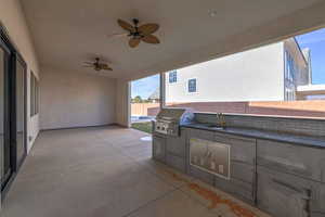 View of terrace featuring sink, ceiling fan, exterior kitchen, and area for grilling