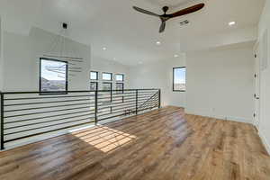 Unfurnished room with ceiling fan and hardwood / wood-style flooring