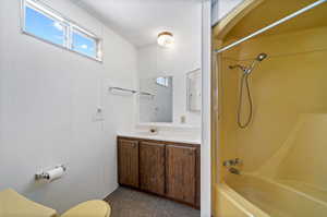 Full bathroom featuring bathtub / shower combination, vanity with extensive cabinet space, and toilet