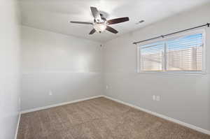 Spare room with ceiling fan and carpet flooring