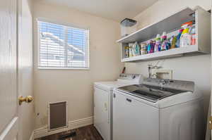 Washroom featuring washer hookup, dark hardwood / wood-style flooring, and washer and clothes dryer