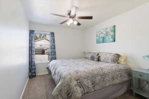 Carpeted bedroom with ceiling fan