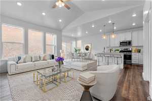 Living room featuring sink, dark hardwood / wood-style floors, lofted ceiling, and ceiling fan