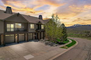 View of front of house featuring a garage, a balcony, and a mountain view