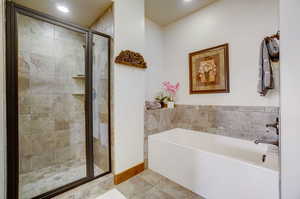 Bathroom with tile floors and plus walk in shower