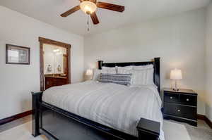 Bedroom with light colored carpet and ceiling fan