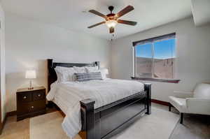 Bedroom featuring ceiling fan and light colored carpet