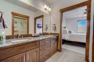 Bathroom with dual vanity and ceiling fan