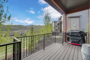 Wooden deck with a grill and a mountain view