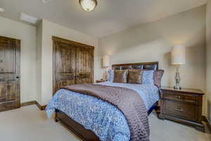 Bedroom featuring light carpet