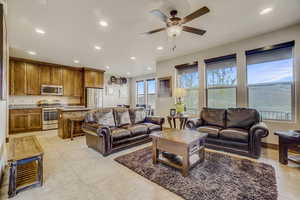 Tiled living room featuring ceiling fan