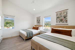 Bedroom featuring light hardwood / wood-style flooring, ceiling fan, and lofted ceiling