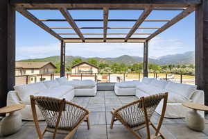 View of patio with a pergola, an outdoor living space, and a mountain view