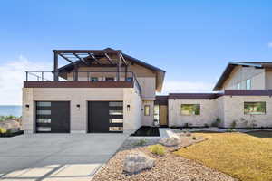 Contemporary home featuring a garage and a balcony