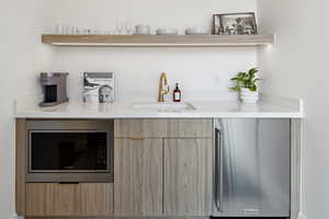 Bar featuring built in microwave and sink