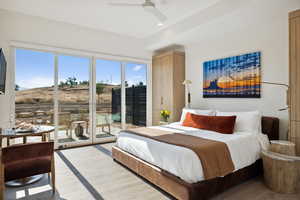 Bedroom with access to exterior, ceiling fan, and hardwood / wood-style flooring