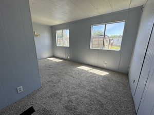 Empty room featuring carpet floors and a textured ceiling