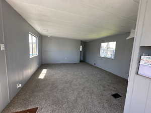 Spare room featuring a textured ceiling and carpet flooring